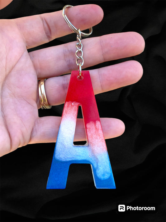 Resin / Epoxy Keychain Letter  - Hand poured and uniquely made. Size 2 1/2" x 1 1/2” Red, White & Blue Patriotic